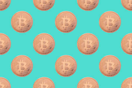 Seamless pattern of gold coin bitcoin on a blue background close-up. Physical bit coins background. Digital currency background. Electronic money conceptの写真素材