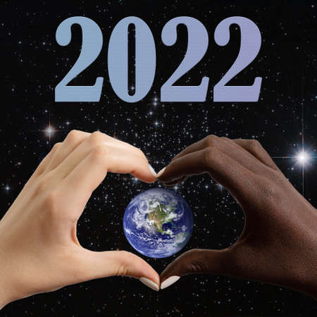 Black and white hands in the shape of a heart, planet Earth against the background of the starry sky...