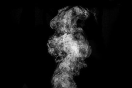 Curly white steam, Fog or smoke isolated transparent special effect on black background. Abstract mist or smogの写真素材