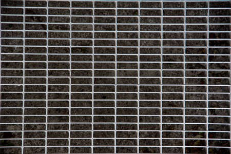Old metal grating in the sidewalk. The metal gauze of a drainage, Close-up, top view, flat layの写真素材