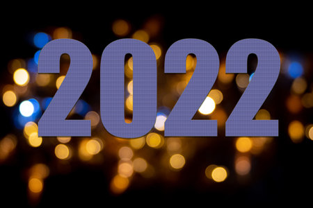 Purple numbers 2022 on yellow, gold, blue circles, bokeh on a dark background. Decorative background