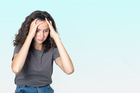 Mental health concept. Upset sad teenager girl suffering from loneliness, holding her head with her...