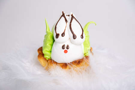 Homemade protein cake in the shape of an Easter Bunny lying in the grass against the background of...