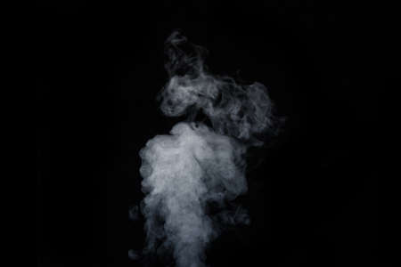 Curly white steam rising up and splashing water scattering in different directions isolated on a black background. Can be used as background, design elementの写真素材