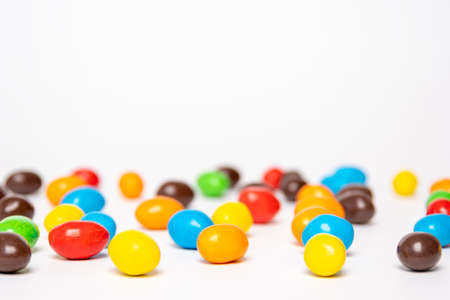 Background of colorful rainbow round candies, copy space, selective focus. Treats for children. Sweets, lollipops based on sugar.の写真素材