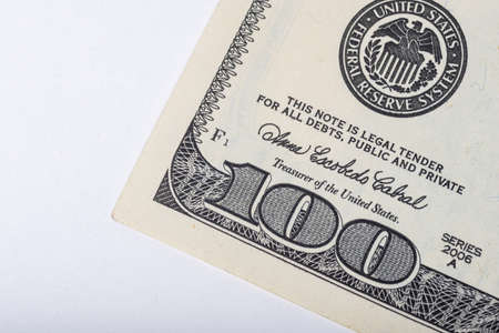 Fragment of 100 dollar bill isolated on white background. Saving concept. The stability of the national currency. Wealth concept.の写真素材