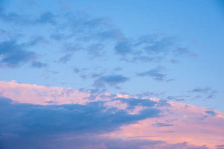 Abstract pink sunset sky and dark blue clouds background with motion blur. Bright pink-blue sky...