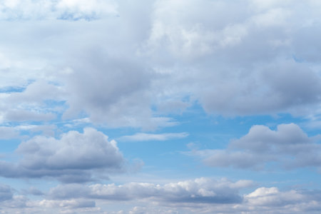 Lots of cumulus clouds far on horizon on blue daylight sky. Light blue sky with clouds, fresh...