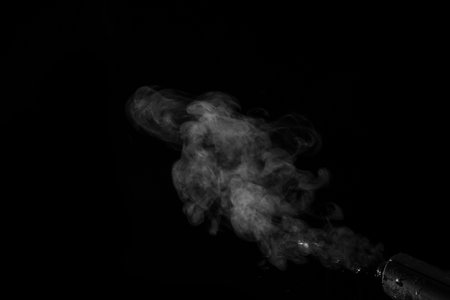 White curling dense smoke steam rising up is isolated on black background to overlay your photos....