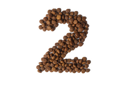 Number 2 made from dry pet food on a white background. Design, layout. Dietary therapeutic nutrition...