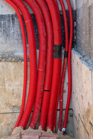 Red plumbing pipe close-up. Drainage, tubing, pipes. Red pipes of the water supply and heating system. Installation of a water supply system in a country houseの写真素材