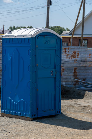 Mobile blue plastic toilet on the street. Individual hygiene products at the construction site. Portable toilet on the street in the cityの写真素材
