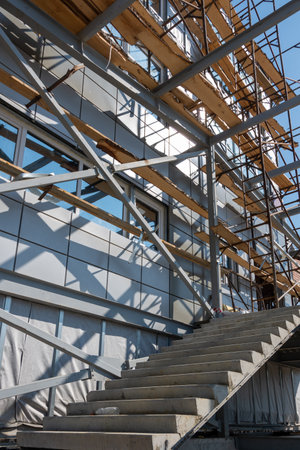 Construction of a building using scaffolding. Facade restoration work. Fragment of scaffolding and...