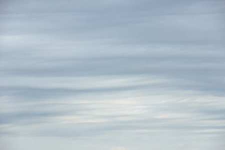 Dense gray thunderstorm cumulus wavy clouds in the whole frame. Gloomy rainy Sky background to overlay on your photos. Perfect sky to replace the backgroundの写真素材