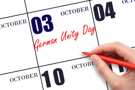 October 3. Hand writing text German Unity Day on calendar date. Save the date. Holiday.  Important date. Day of the year concept.の写真素材