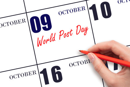 October 9. Hand writing text World Post Day on calendar date. Save the date. Holiday.  Important date. Day of the year concept.の写真素材