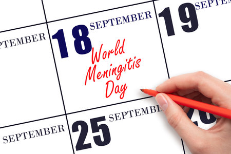 September 18. Hand writing text World Meningitis Day on calendar date. Save the date. Holiday. Important date. Day of the year concept.の写真素材