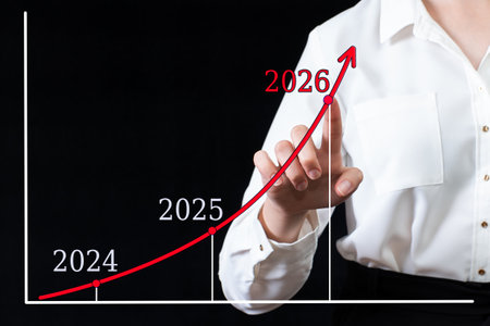 A businessman points his hand on an arrow chart with high growth rates in 2026 versus 2024 and 2025. The woman plans to increase financial performance in 2026. Financial, sales profitの写真素材