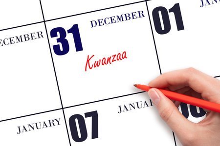 December 31. Hand writing text Kwanzaa on calendar date. Save the date. Holiday. Day of the year concept.の写真素材