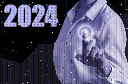 The business concept of 2024. A female hand pressing a virtual button showing a dot on a graph with the inscription 2024. The concept of growth, new goals, and developmentの写真素材