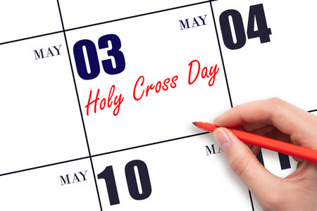 May 3. Hand writing text Holy Cross Day on calendar date. Save the date. Holiday. Planning or scheduling concept.の写真素材