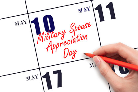 May 10. Hand writing text Military Spouse Appreciation Day on calendar date. Save the date. Holiday. Planning or scheduling concept.の写真素材
