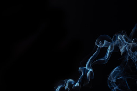 Blue smoke swirls in abstract form, photography style on black background. Concept of mystery and creativity. Swirling, writhing smoke to overlay on your photosの写真素材