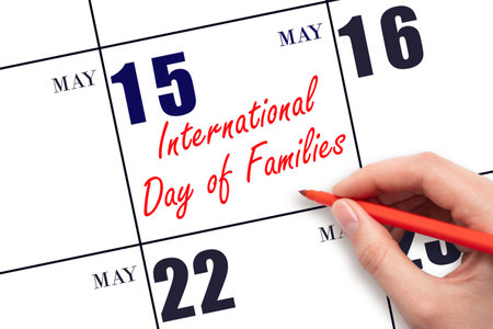 May 15. Hand writing text International Day of Families on calendar date. Save the date. Holiday.  Planning or scheduling concept.の写真素材