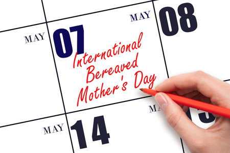 May 7. Hand writing text International Bereaved Mother's Day on calendar date. Save the date. Holiday. Planning or scheduling concept.の写真素材