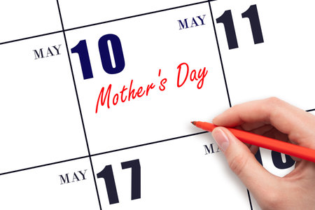 May 10. Hand writing text Mother's Day on calendar date. Save the date. Holiday. Planning or scheduling concept.の写真素材