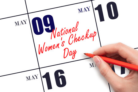 May 9. Hand writing text Women's Checkup Day on calendar date. Save the date. Holiday. Planning or scheduling concept.の写真素材