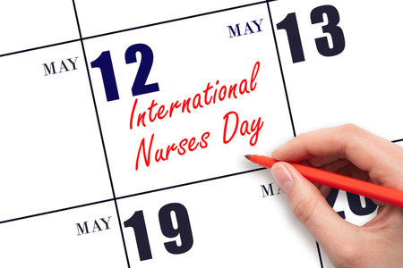 May 12. Hand writing text International Nurses Day on calendar date. Save the date. Holiday. Planning or scheduling concept.の写真素材