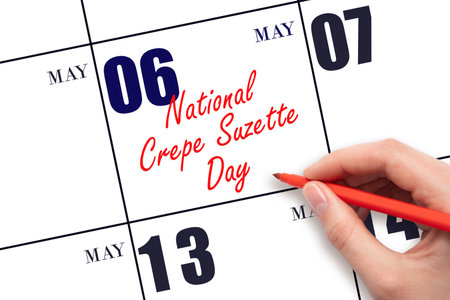 May 6. Hand writing text National Crepe Suzette Day on calendar date. Save the date. Holiday. Planning or scheduling concept.の写真素材