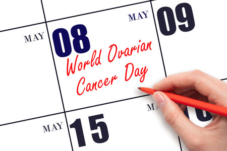 May 8. Hand writing text World Ovarian Cancer Day on calendar date. Save the date. Holiday. Planning or scheduling concept.の写真素材