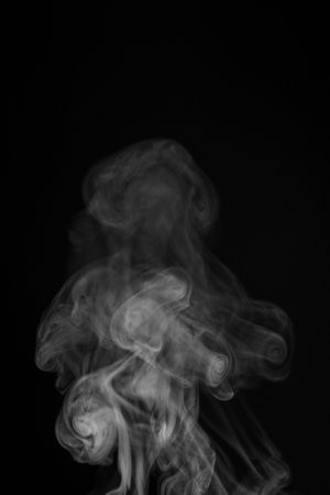 White smoke swirls in abstract form, photography style on black background. Concept of mystery and creativity. Swirling, writhing smoke to overlay on your photos.の写真素材
