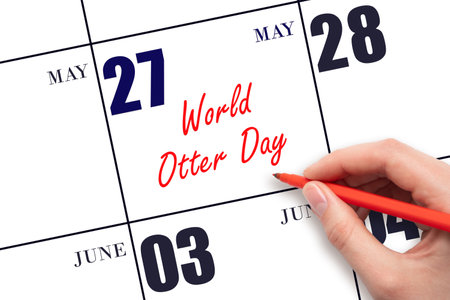 May 27. Hand writing text World Otter Day on calendar date. Save the date. Holiday.  Planning or scheduling concept.の写真素材