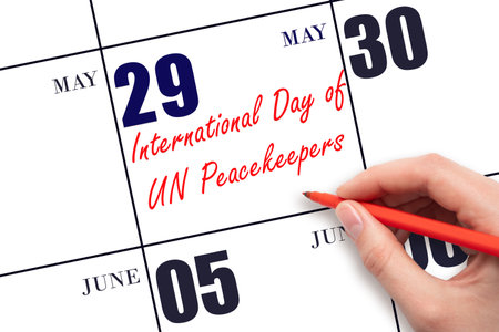 May 29. Hand writing text International Day of UN Peacekeepers on calendar date. Save the date. Holiday.  Planning or scheduling concept.の写真素材