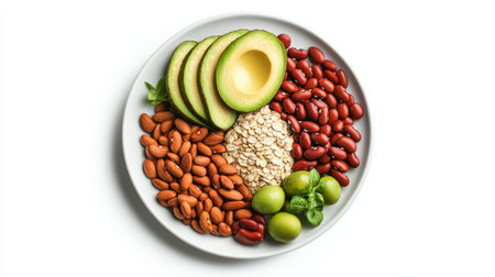 Fresh avocado half, spinach leaves, red and black beans for heart health on a white plate, top view on a white background, symbolizing healthy vegan nutrition.の素材