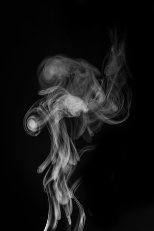 Ethereal smoke swirling gracefully in the air creating abstract shapes and patterns for artistic expression concept. graphic resource for montage, overlay or texture.の写真素材