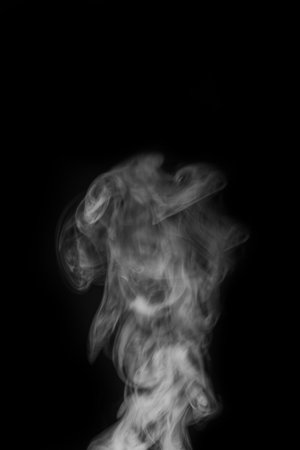 Ethereal wisps of smoke swirling gracefully against a dark background creating a captivating visual experience smoke art concept. graphic resource for montage, overlay or texture.の写真素材