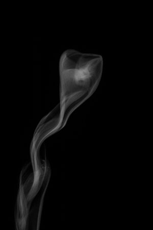 White hot curly steam smoke isolated on black background. Abstract background, design element, for overlay on pictures. Create mystical Halloween photos.の写真素材