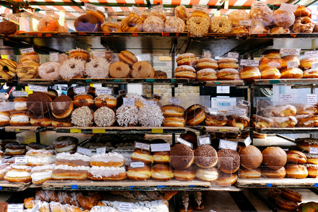 Variety of doughnuts on a market stall in a small street in Camden Town, London, UK