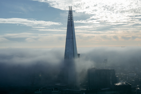 LONDON, UK - DECEMBER 29, 2016: London and Shard, the highest building in the city, consumed by fog, bird's eye viewのeditorial素材
