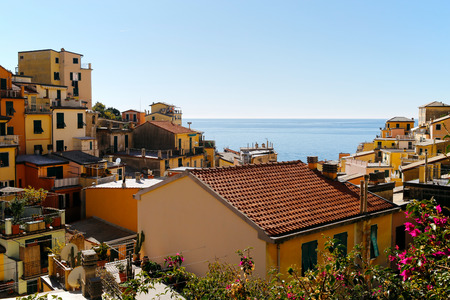 One of Cinque Terre villages, Riomaggiore, with blue sea and sky in the background. Cinque Terre was included as a UNESCO World Heritage Site in 1997.のeditorial素材