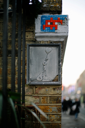 Wall art in Brick Lane dedicated to a choice between love and money.