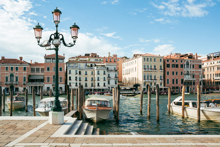 Private boats and taxis moored on Grand Canal in Venice on a bright summer day. Boats are the main mode of transport in the city.のeditorial素材