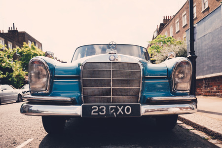 Front view of old blue Mercedes-Benz 600 parked on a side of a road in London on a sunny day. The...