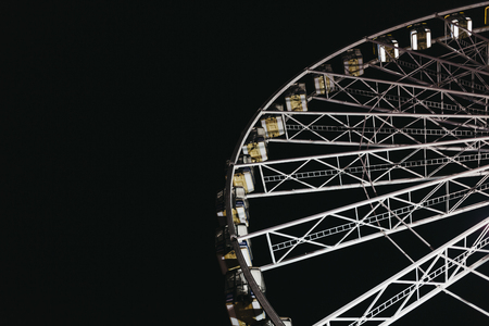 LONDON, UK - NOVEMBER 18, 2017: Ferris wheel in Winter Wonderland, annual Christmas Fair in London, UK, against dark sky in evening. Space for copy.のeditorial素材