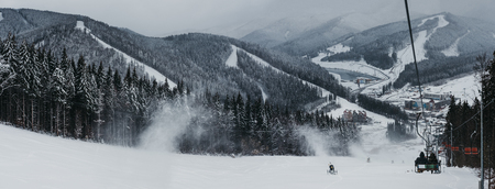 Panoramic view of Bukovel ski resort from ski lift, snow, mountains and trees on the background. Bukovel is one of the most popular winter sport resorts in Ukraine.の写真素材