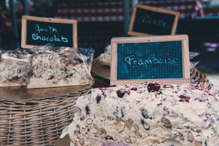 Homemade cake on sale at a market, sliced, on wooden stand.の写真素材